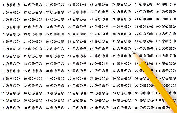 A scantron answer sheet with a pencil and bubbled answers stock photo