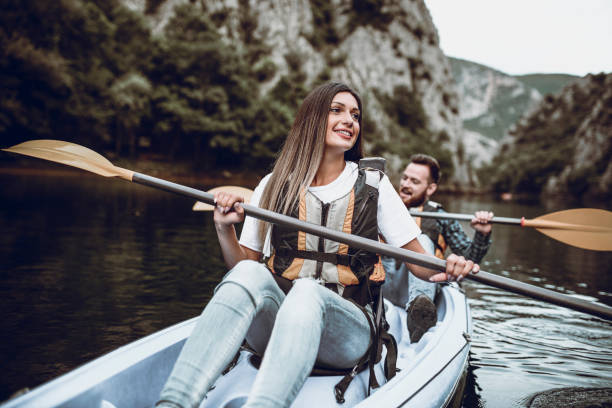 istock Cute Young Couple Having Fun During Kayaking Vacation On Lake 977059072