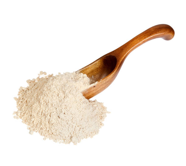 istock Ground Ginger Zingiber officinale in the wooden spoon, isolate 977083514