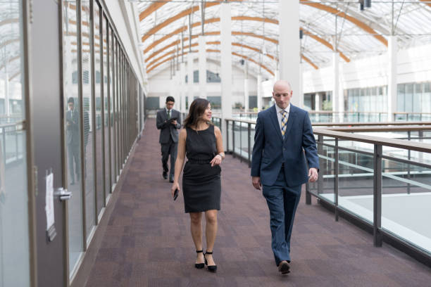 istock Two colleagues talking on their way to a meeting 977086656