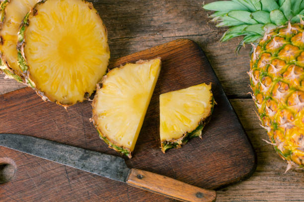 istock sliced pineapple on wood 977088110