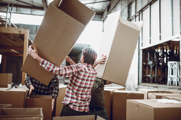 istock Warehouse Workers Preparing Boxes For Furniture Packing 977119194