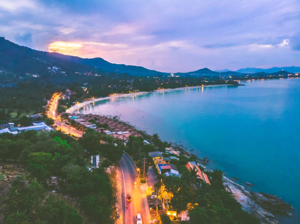 istock High Angle View Of Illuminated City By Sea Against Sky 977123548