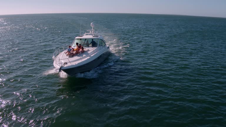 Aerial view of friends relaxing on yacht deck