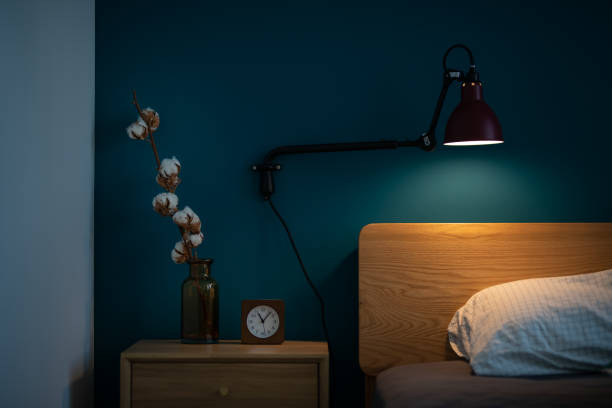 istock table lamp lighted up the bed pillow in the bed  room 977193782
