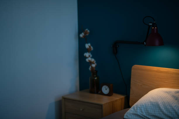 Alarm clock on night table in bedroom