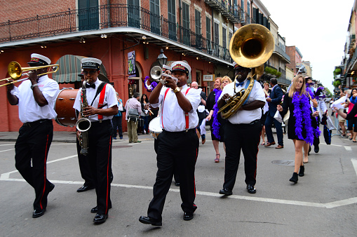 New Orleans, LA, USA October 27, 2015 A group of musicians form a Second Line parade as they march through the French Quarter of New Orleans, Louisiana