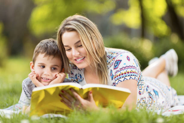 istock Young mother and son lying on blanket in park 977221054