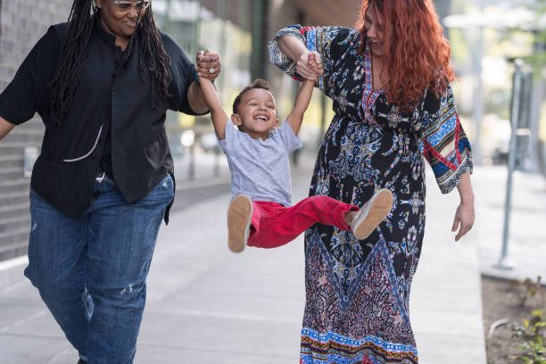 istock Female couple walking with their son 977263494