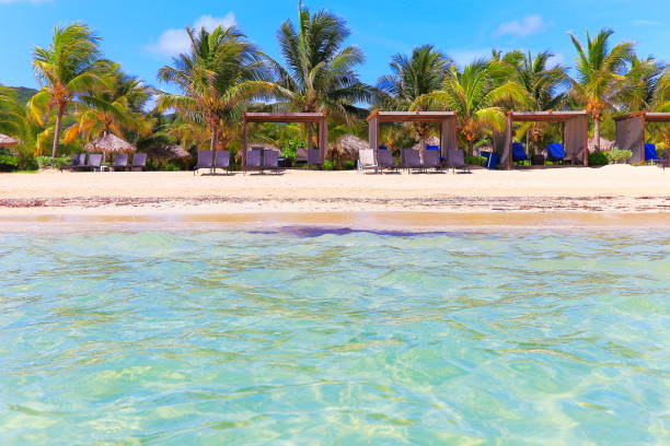 istock Beach with relaxing gazebos and beach chairs – Montego Bay - Jamaica 977272448