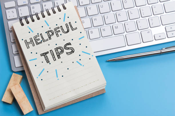 istock Word text Helpful tips on white paper on office table / business concept 977276524