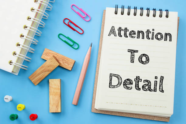Text Attention to detail on white paper book and office supplies on blue desk / business concept Text Attention to detail on white paper book and office supplies on blue desk / business concept canoodling stock pictures, royalty-free photos & images