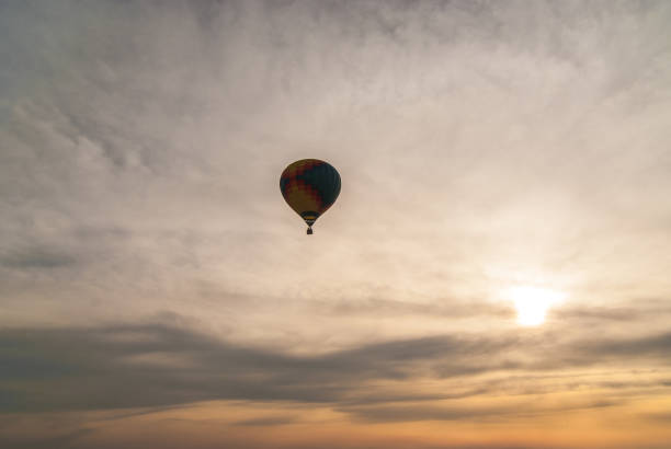 istock Colorful hot air balloon is flying on the sunset 977279982