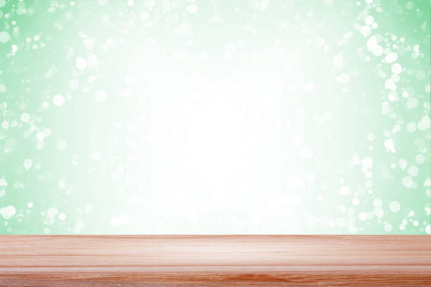 istock Empty wood table with backdrop blurred light green bokeh background, Can be used for display your product 977288580