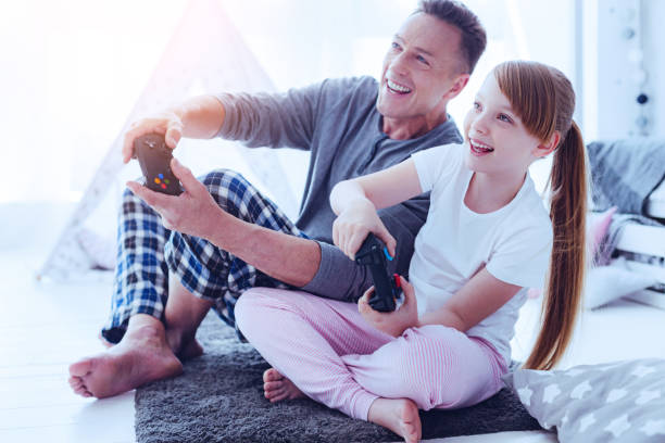 istock Joyful family playing video games together 977297384
