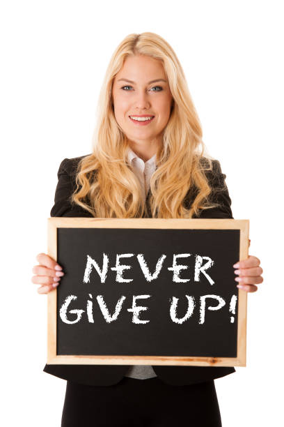 istock business woman holding a blank blackboard - teacher 977297862