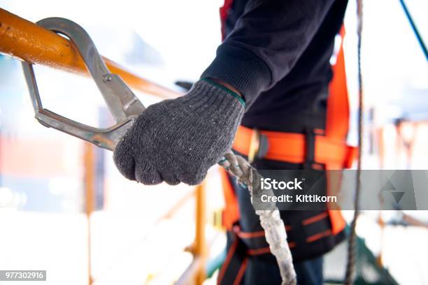 Construction Worker Use Safety Harness And Safety Line Working On A New Construction Site Project Stock Photo - Download Image Now