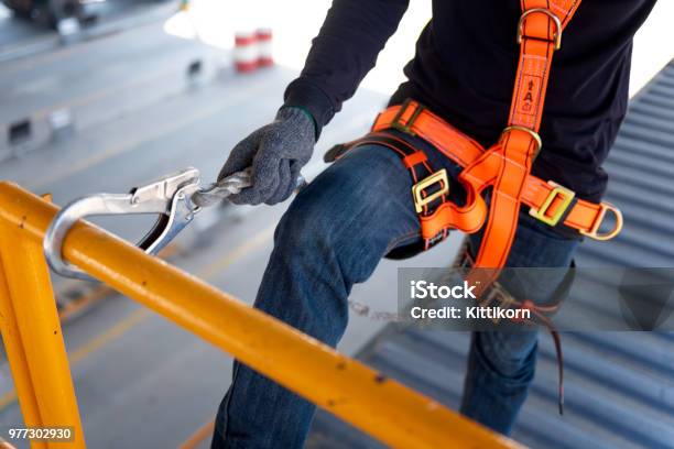 Construction Worker Use Safety Harness And Safety Line Working On A New Construction Site Project Stock Photo - Download Image Now