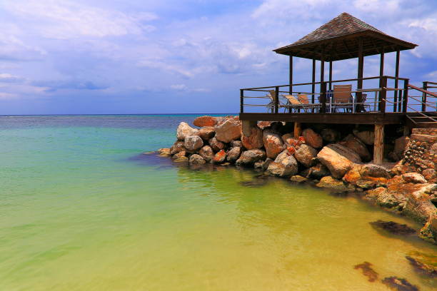 istock Beach with rustic gazebo on breakwater – Montego Bay - Jamaica, Caribbean 977303188