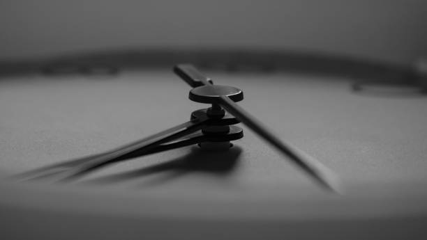 istock Black and white picture of clock hands 977308182