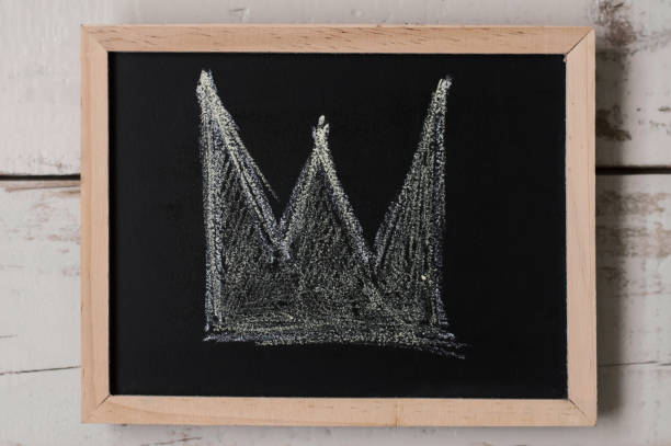 istock A crown drawn on small blackboard. Wealth and authority symbol 977311190
