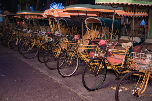 istock Empty typical chinese rickshaws on night street of Macau 977325074