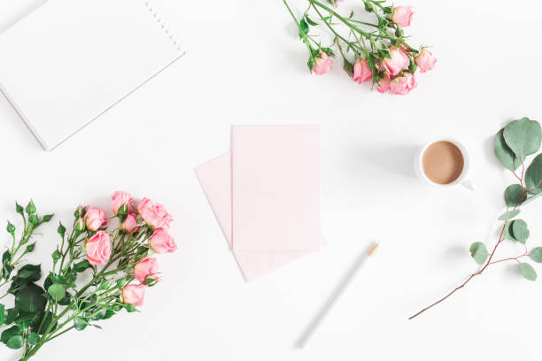 istock Notebook, rose flowers, eucalyptus branch, pink paper blank, coffee 977365396