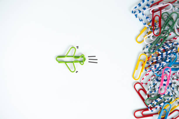 business concept for group of stacked paperclip with another one green plane paperclip is point to another direction as a team leadership - toy spaceship inspiration ideas imagens e fotografias de stock