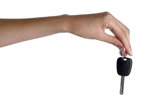 woman holding car key, close-up stock photo