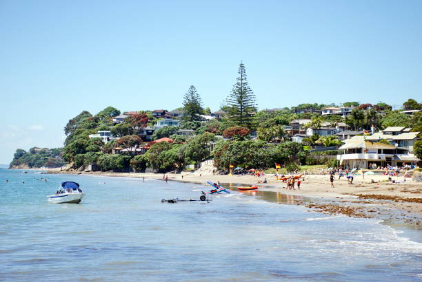 Surf Life Saving New Zealand Flags, Mairangi Bay, Auckland, New Zealand Mairangi Bay crowded with people and the Surf Life Saving New Zealand Boat and Flags, North Shore City, Auckland, New Zealand north shore stock pictures, royalty-free photos & images