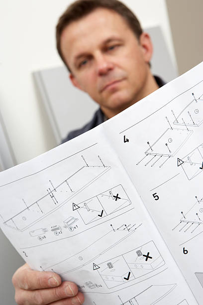 istock Man Reading Assembly Instructions For Furniture 97740049