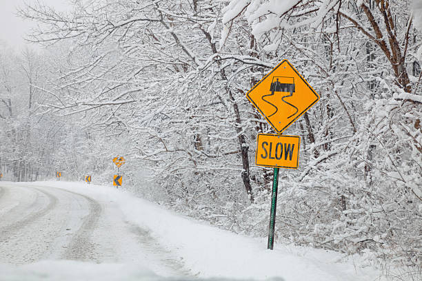 istock Snow covered road with Slow sign 97740243