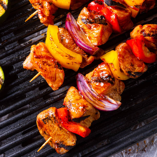 istock Rustic shish kebab skewers with marinated ham meat paprika and red onion 977422544
