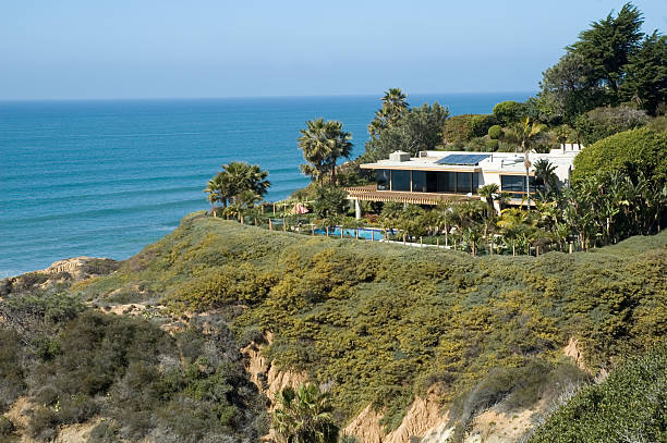 istock Beach house on top of cliff with sea in background 97743721