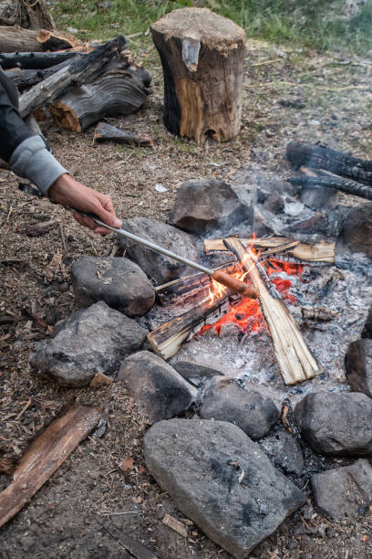istock Cooking sausage on camp fire in Russia 977438632