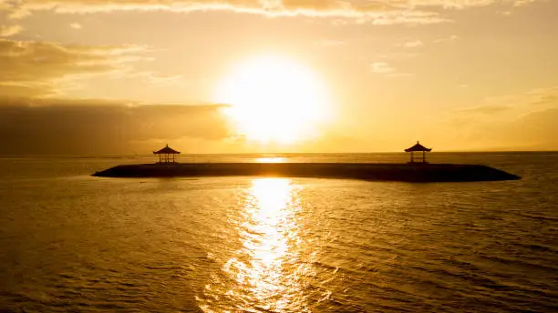Picture of beautiful sunset with bright golden sunbeam at Sanur beach in Bali, Indonesia