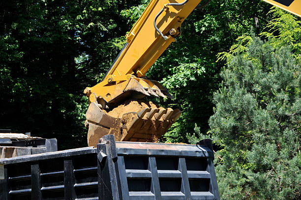 Excavator Empties Dump Truck stock photo