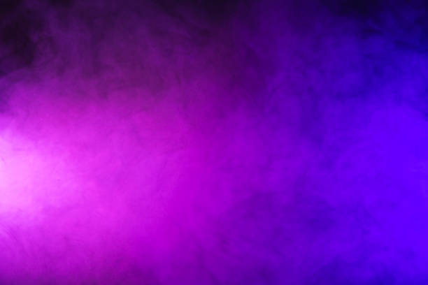 istock abstract pink and purple smoke on dark background 977441886