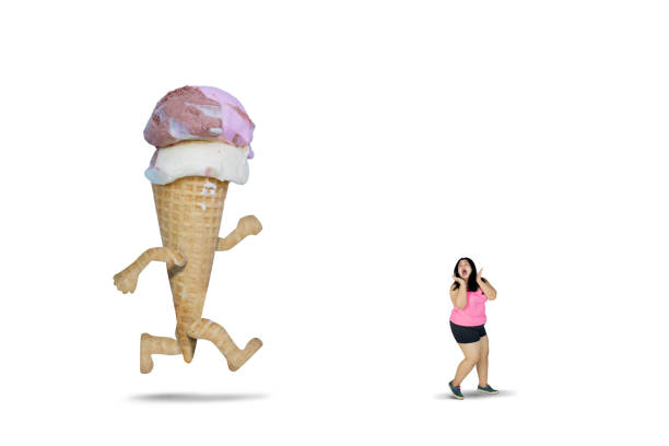 istock Big ice cream chasing fat woman on studio 977442106