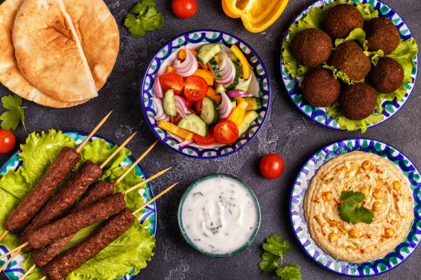 istock Classic kebabs, falafel and hummus on the plates. 977443126