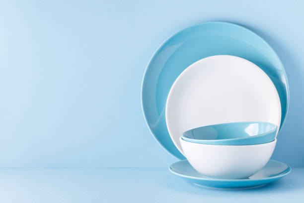 istock Crockery and cutlery on a blue pastel background 977443170