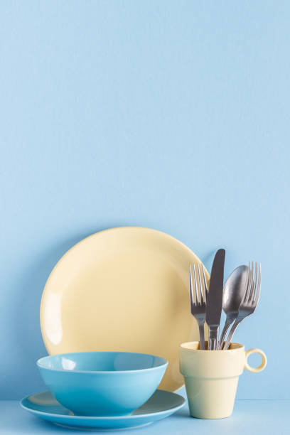 istock Crockery and cutlery on a blue pastel background 977443172