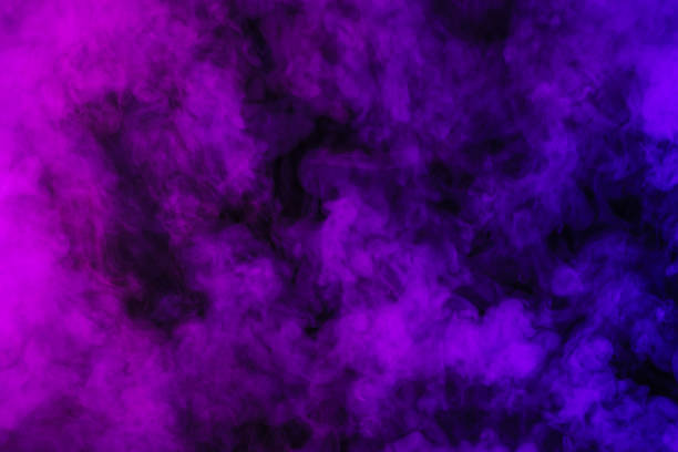 istock purple smoke on abstract black background 977443576