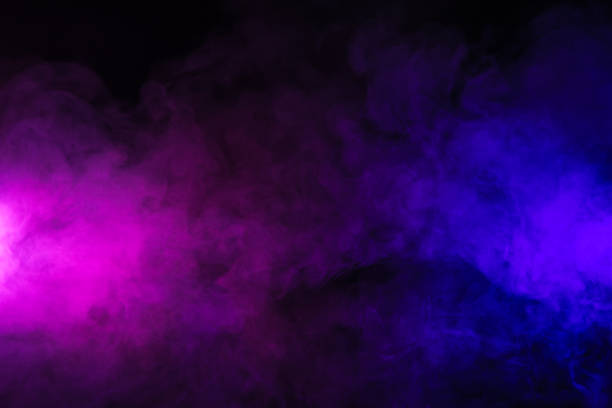 istock pink and purple smoke on abstract black background 977443606