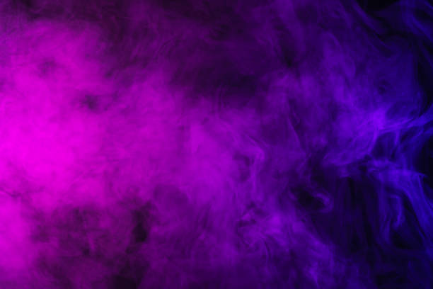 istock abstract pink and purple smoke on black background 977446124