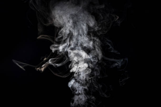 istock grey smoky swirl from cigarette on black 977446528