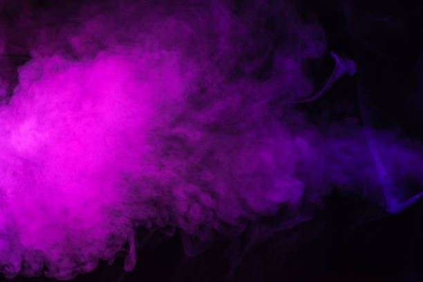 istock mystical pink smoke on black background 977447064