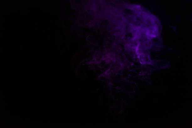 istock mystical black background with purple smoke 977447338