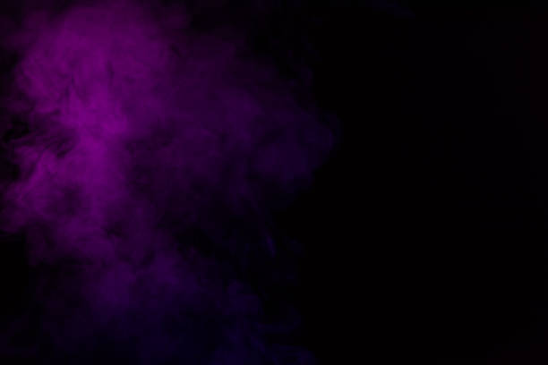 istock mystical abstract black background with violet steam 977450910