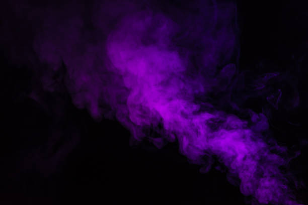 istock abstract black background with purple steam 977451534